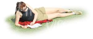 woman lying on the grass and reading a book