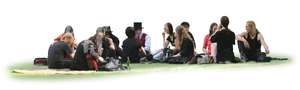 large group of people sitting together on the grass