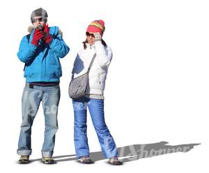 man and woman in winter clothes standing and taking pictures