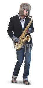 man playing saxophone on the street during winter time