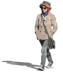 woman in a hat and coat walking