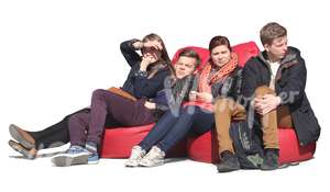 group of youngsters sitting on cushions