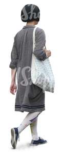 asian woman in a grey dress walking in shade