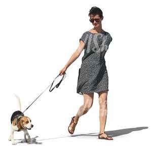 woman in grey dress walking a dog