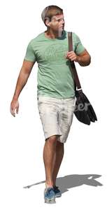 man in a green t-shirt walking