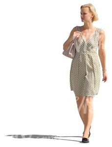 blond woman in a white dress walking on the street