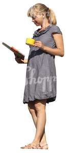 woman with a coffee cup standing on the balcony