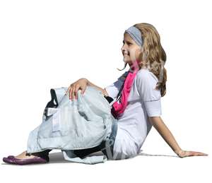 young girl sitting on the gound