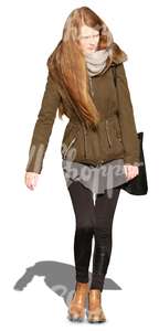 long-haired woman in a khaki parka walking towards the camera