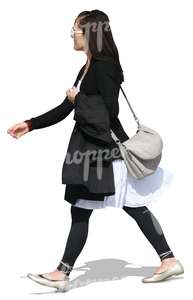 young woman in black and white clothes walking