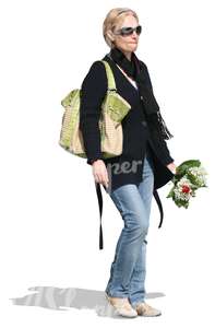 woman holding a bouquet of flowers walking