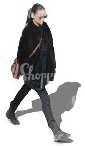 woman in a black fur coat walking hands in her pocket
