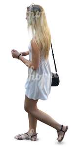 blonde woman in a white summer dress walking