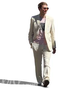 man in a white suit walking and smiling