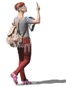 woman walking and taking a picture with a phone