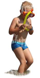 boy with a snorkeling mask standing in the water