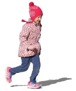 young girl with a red hat running