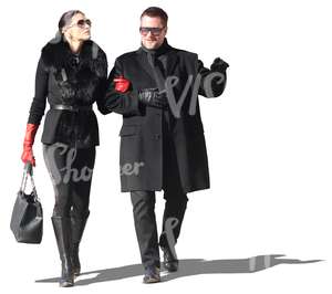 posh couple dressed in black walking arm in arm