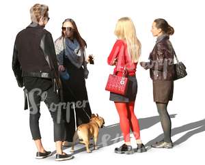 group of people and a dog standing in a circle
