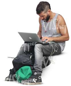 man sitting and working on his computer