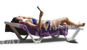 woman sunbathing on a beach chair