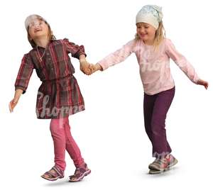 two smiling girls walking hand in hand