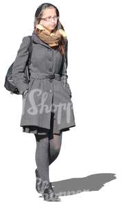 young woman in grey outfit walking