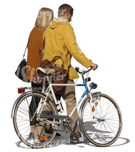 man and woman walking next to a bicycle