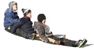 three boys sliding down an icy mountain