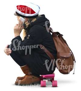 schoolgirl sitting on a skateboard