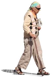 elderly woman with sunglasses walking with a stick