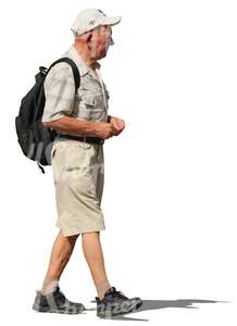 elderly man with a backpack walking