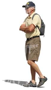elderly man with a backpack walking