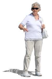 elderly woman in a white outfit standing