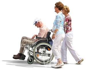 two women pushing a man in a wheelchair