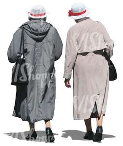 two elderly women wearing coats walking