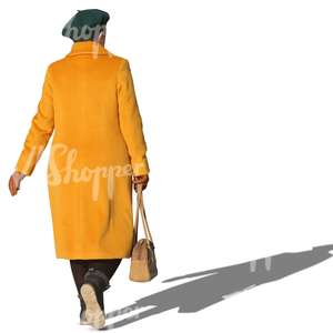 elderly woman in a yellow coat walking