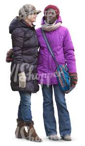 two women in winter clothes standing and talking