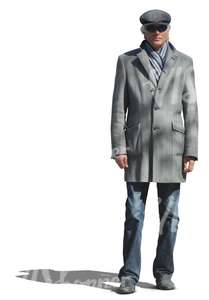 elderly man on a grey coat standing
