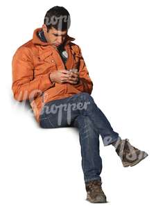 man sitting and looking at his smartphone