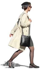 businesswoman in a white coat walkinbkg