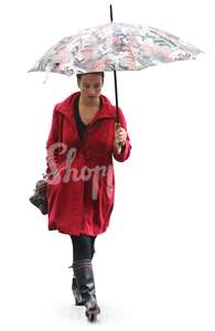 woman in a red coat and wellies walking under an umbrella