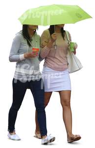 two women with an umbrella walking and drinking coffee