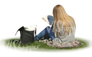 woman sitting on the grass and reading