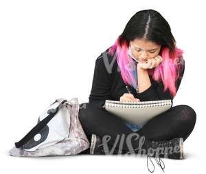 asian woman sitting and writing in her notebook