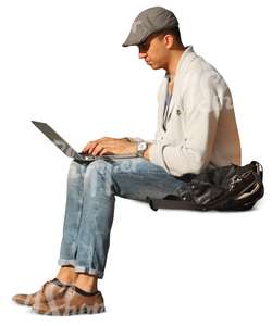 man sitting and working on his laptop