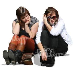 Two girls sitting on the sidewalk