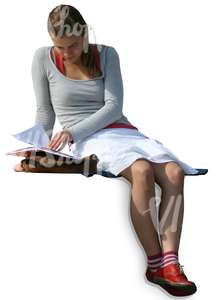 A girl sitting and reading a book