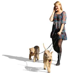 woman with two dogs talking on the phone
