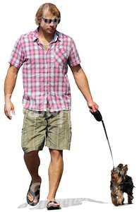 man with sunglasses walking a dog